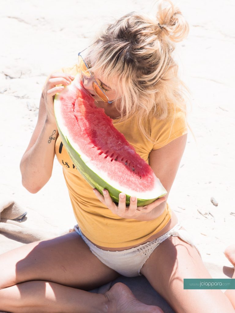 Model Natalia Paris eating watermelon at St Peter's Pool in Malta