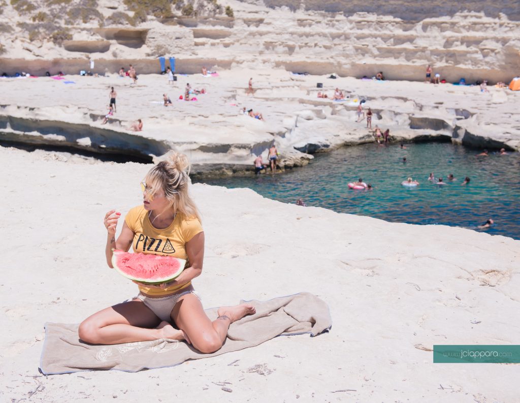 Model Natalia Paris eating watermelon at St Peter's Pool in Malta